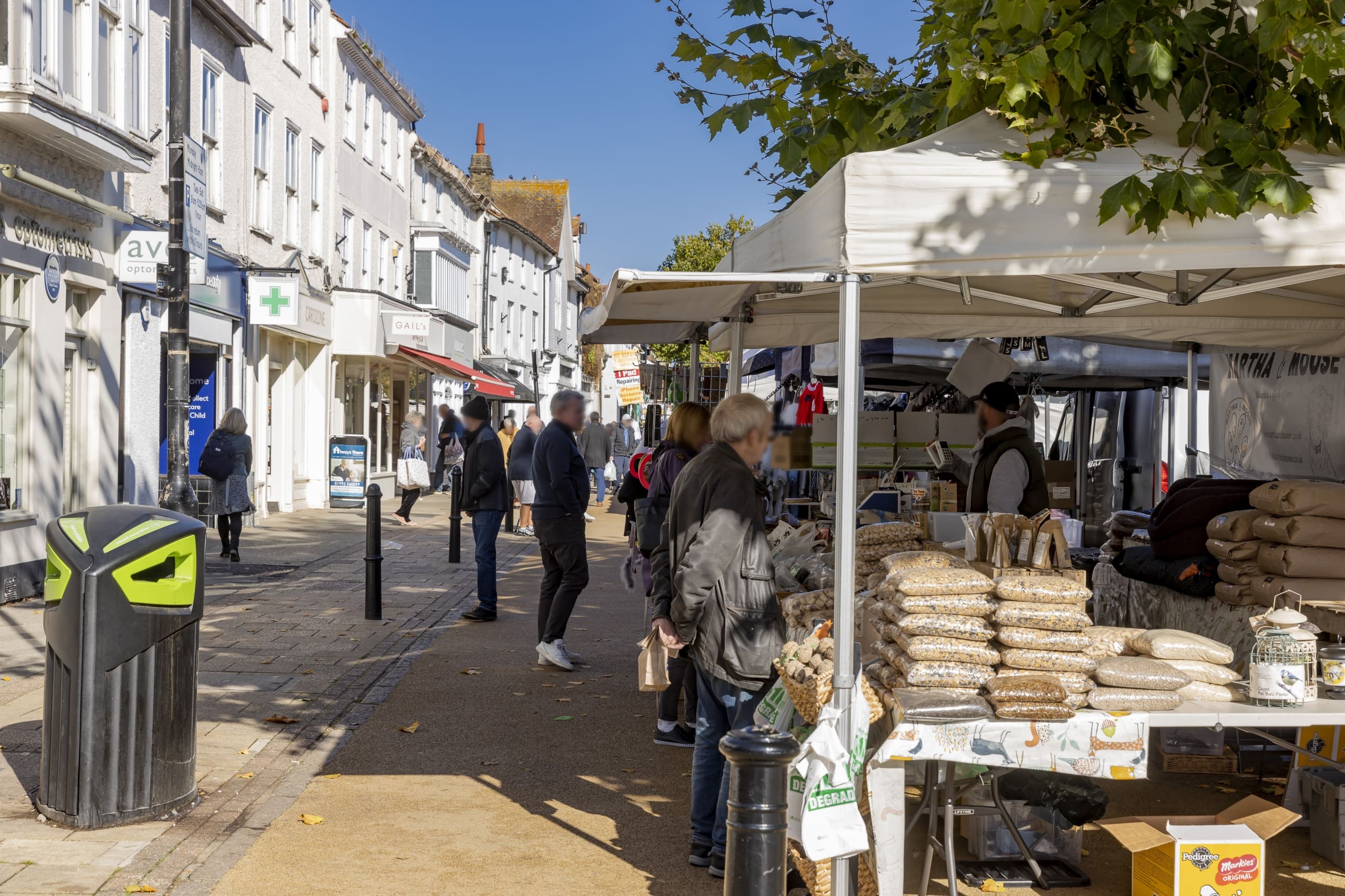 Busy local market stools outside shops on the high street